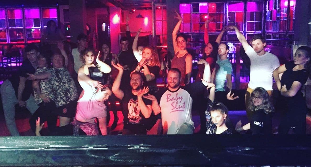 A lively group of dancers in vogue dancing poses
